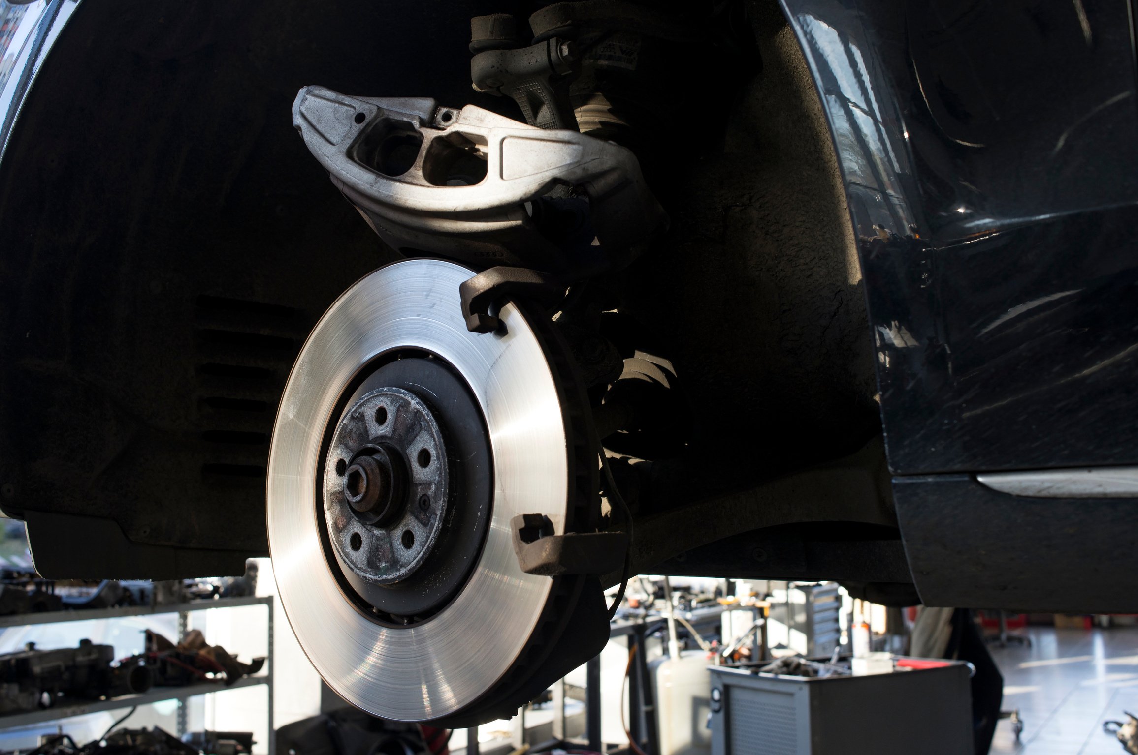 Car brake part at garge, car brake disc without wheels closeup